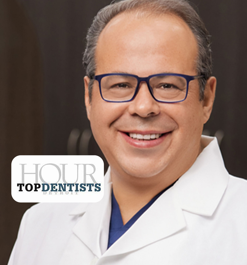 a person wearing glasses and smiling at the camera